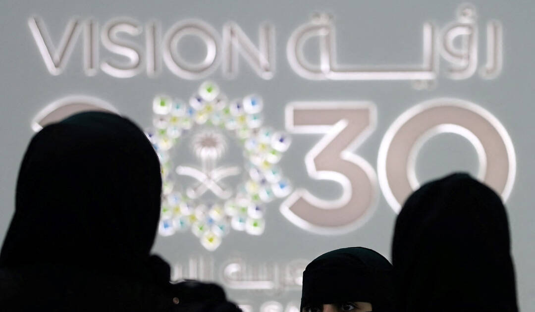Saudi women stand next to the Saudi pavilion (vision 2030) at the Gitex 2018 exhibition in Dubai on October 16, 2018. (AFP)