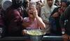 A young displayed Palestinian girl reacts as she receives a portion of food, at a shelter where families have been living.
