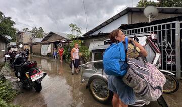 Residents carrying their belongings evacuate their homes ahead of the arrival of Super Typhoon Fung-wong in Tuguegarao City.