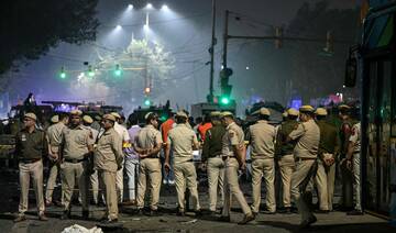 Security personnel gather at the blast site after an explosion near the Red Fort in the old quarters of Delhi.