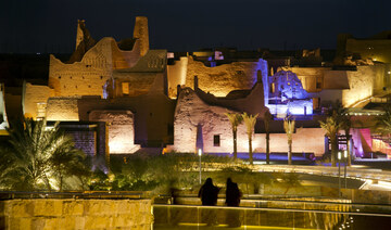 Visitors watch ancient palaces of the 18th century Diriyah fortified complex in Riyadh, Saudi Arabia. (AP)