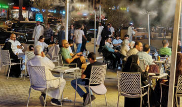 People watch a soccer game at an open air seating as summer heat gradually eases, in Riyadh, Saudi Arabia. (REUTERS)