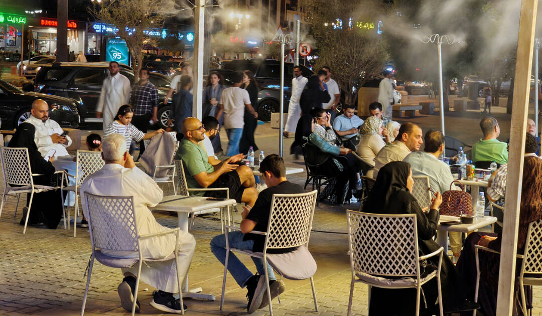 People watch a soccer game at an open air seating as summer heat gradually eases, in Riyadh, Saudi Arabia. (REUTERS)